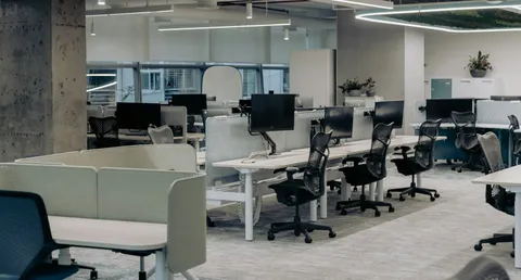 An empty modern office with rows of desks