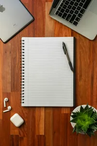 A pen resting on an open notebook