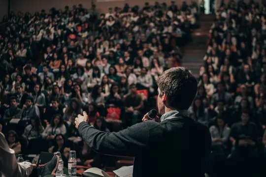 A speaker addressing a large audience