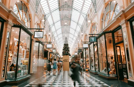 A busy shopping arcade decorated for the holidays