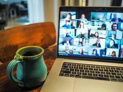 A laptop displaying a group video call